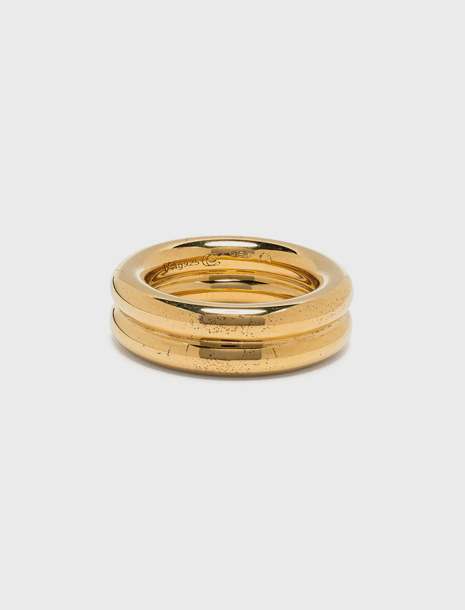 Gold ring with a textured surface on a light gray background