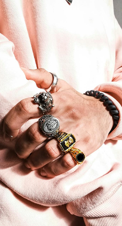 Close-up of a hand wearing multiple bracelets.
